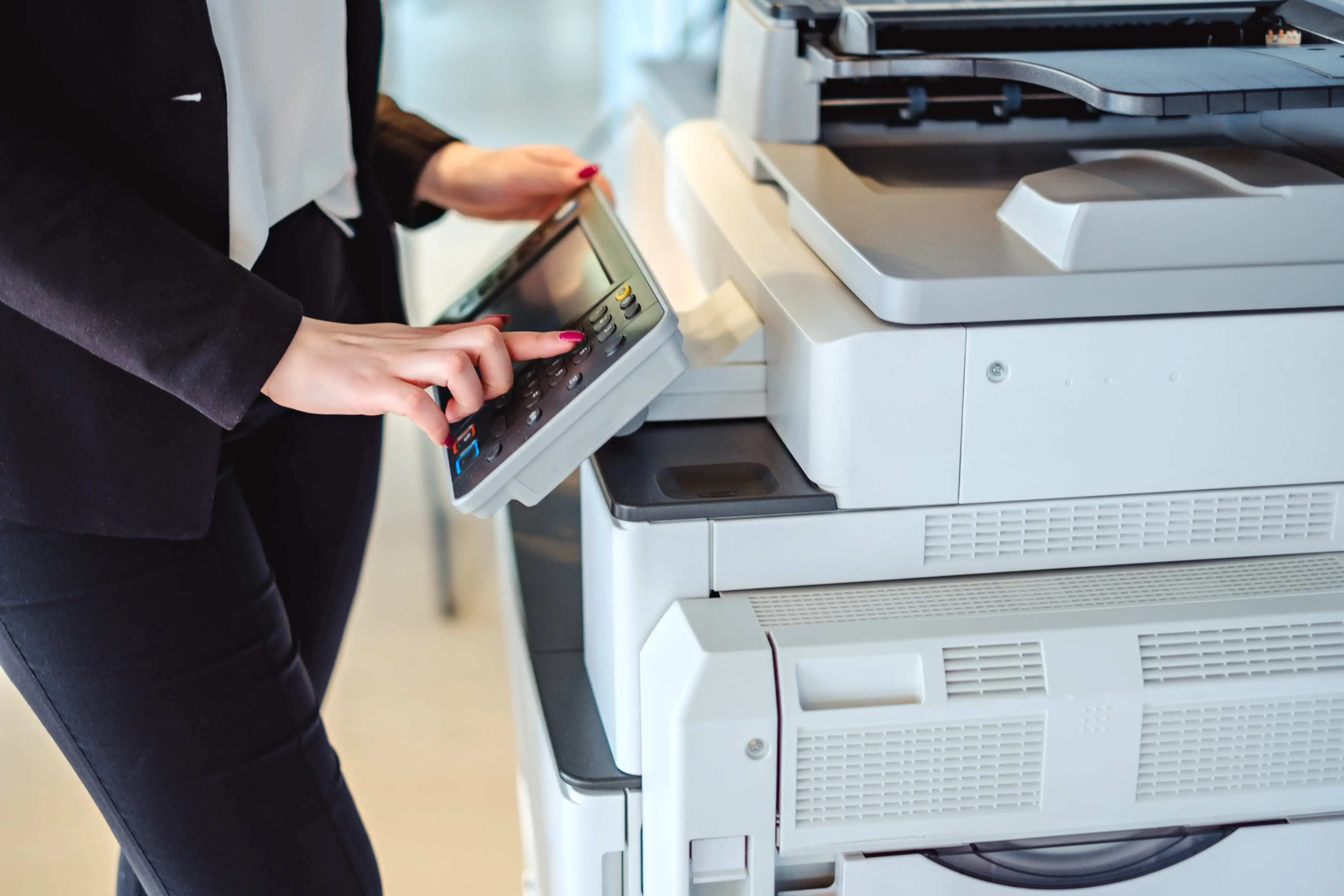 Female financial advisor using a printer.